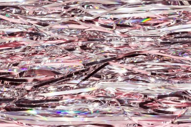 pink shiny tinsel background. festive or party wallpaper.