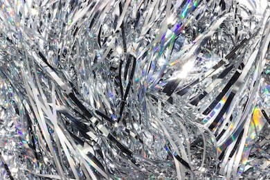 silver shiny holographic tinsel background. festive or party wallpaper.
