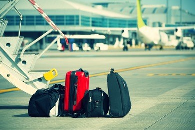 baggage in front of the airplane