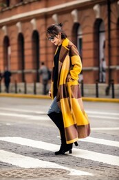 asian fashion girl wearing yellow trench coat in the street