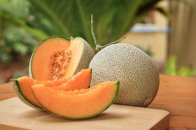 whole and sliced of japanese melons,honey melon or cantaloupe (cucumis melo) on wooden table background.favorite fruit in summer.food,fruits or healthcare concept.