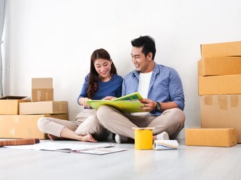 asian couple choosing colour palette for their new house, lifestyle concept.