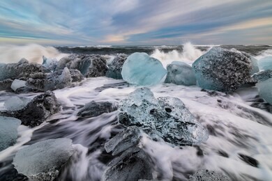 ice rock with black sand beach at jokulsarlon beach at sunset. diamond beach in southeast iceland.