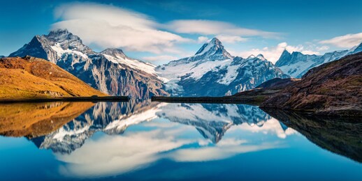 panoramic morning view of bachalp lake / bachalpsee, switzerland. majestic autumn scene of swiss alps, grindelwald, bernese oberland, europe. beauty of nature concept background.