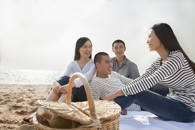 young friends picnic on the beach