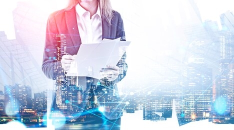 unrecognizable businesswoman with documents standing over night city background with double exposure of network interface. concept of hi tech. toned image