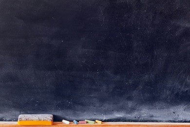 blank blackboard with colored chalks and eraser. horizontal composition.
