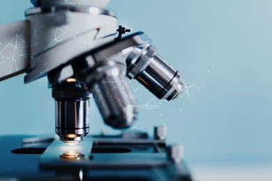 close-up shot of microscope with metal lens with abstract with points, lines, and shapes