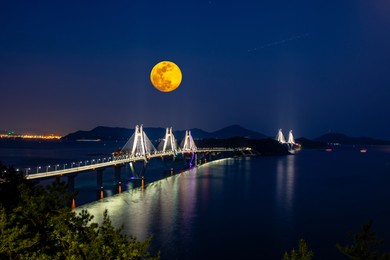 nightscape of the moon over bridge, sea and islands