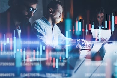 business team working together at night office.technical price graph and indicator, red and green candlestick chart and stock trading computer screen background. double exposure.