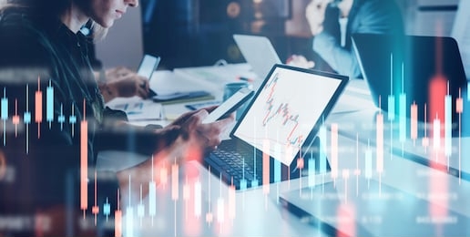 business woman sitting front laptop computer with financial graphs and statistics on monitor. double exposure. wide
