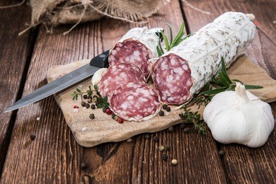 portion of salami slices with fresh herbs and garlic