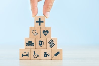 health insurance concept,hand arranging wood block stacking with icon healthcare medical.