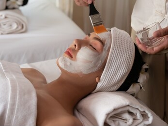 beautiful young asian woman with facial mask at beauty spa salon. beauty treatments