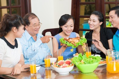 portrait of a family tasting delicious chicken together
