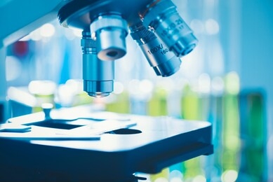 close-up shot of microscope with metal lens at laboratory, modern medical laboratory equipment