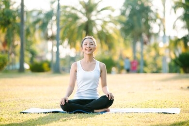 woman on a yoga mat to relax outdoor