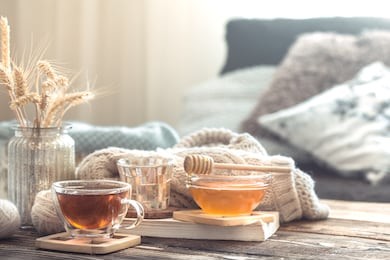 still life details of home interior on a wooden table with a cup of tea, the concept of coziness and home atmosphere .living room