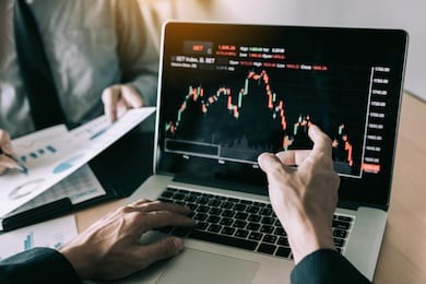 investors are pointing to laptops that have investment information stock markets and partners taking notes and analyzing performance data.