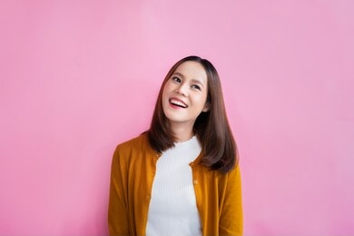 asian women she is refreshing she is looking left. in background studio