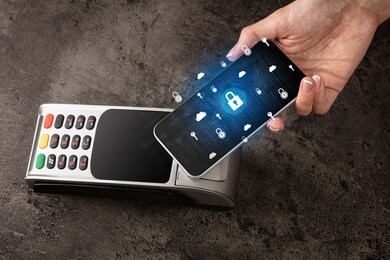 hand paying with cellphone on pos, secure payment concept