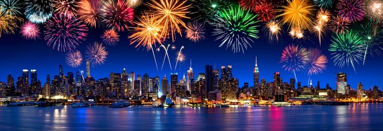 manhattan skyline panorama at night with fireworks, new york city, usa