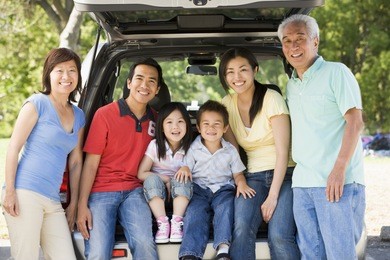 extended family sitting in tailgate of car
