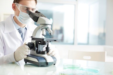 serious clinician studying chemical element in laboratory