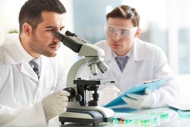 serious clinicians studying chemical elements in laboratory