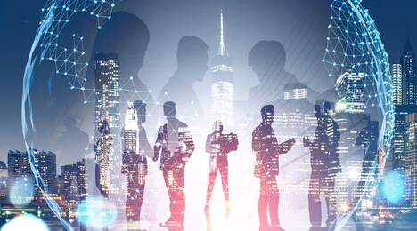 business team members standing over night city background with double exposure of planet hologram. concept of international company and globalization. toned image