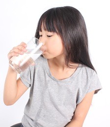 young little girl drinking water.