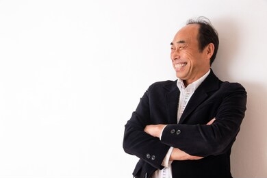 portrait of senior man in front of white wall