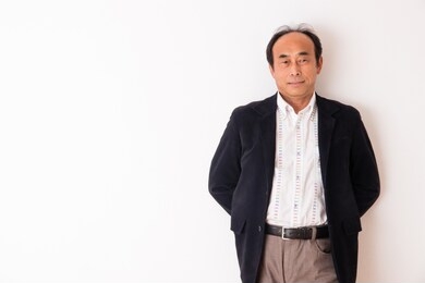 portrait of senior man in front of white wall