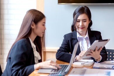 two business woman asian chat exchanging ideas at the meeting.