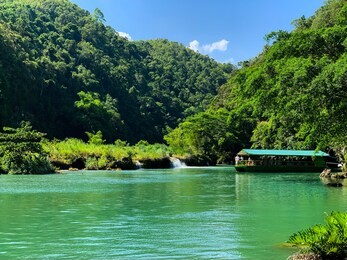 a floating restaurant boat cruising at the beautiful loboc river in bohol, philippines