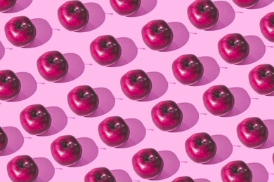 pattern of fresh juicy apples on pink background. minimalism