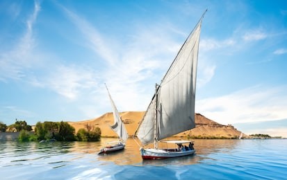 river nile and boats at sunset in aswan