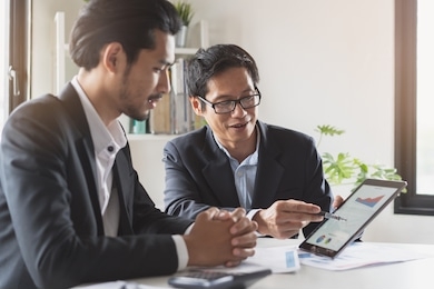 financial advisory services. asian advisor showing plan of investment to clients in the consultancy office.