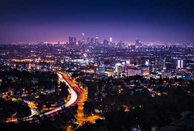 view of downtown los angeles from the hollywood hills.  interstate 101 is shown in the foreground.