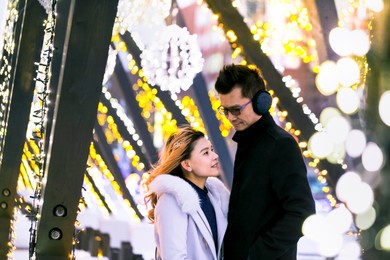 asian couples are honeymooners in the winter in the snow in japan.