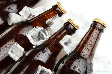 beer bottles in ice cubes close up