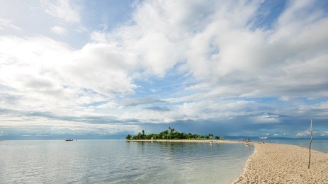 beautiful small tropical island under the sky, the narrow white sand beach stretches like a curving line, one of the most famous travel destinations in local. shot on virgin island, bohol, philippines