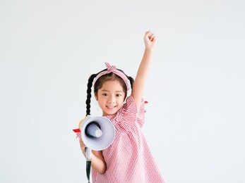 asian cute girl with megaphone singing on white background