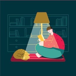 
a man in a dark room reading a book under the light of a floor lamp. in the library on the carpet sleeping cat.