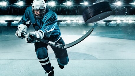 ice hockey player athlete in the helmet and gloves on stadium with stick. action shot. sport concept.