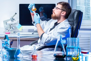 pharmacy laboratory. man scientist mixes a liquid form of medication in a test tube. manufacture of prescription drugs. prescription department. pharmacy production of medicines.