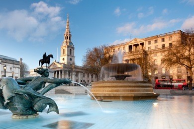 london, fountain on the trafalgar square with st. martin on fields behind