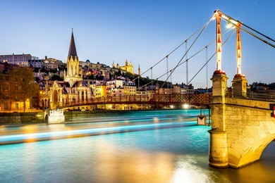 night view from st georges footbridge in lyon city with fourviere cathedral, france