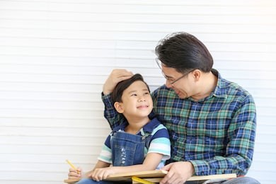 father and son wearing casual chess blue shirt was smiling together with happiness, happy family relationship concept. 