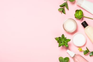 skin care product, natural cosmetic, flat lay image on pink background.